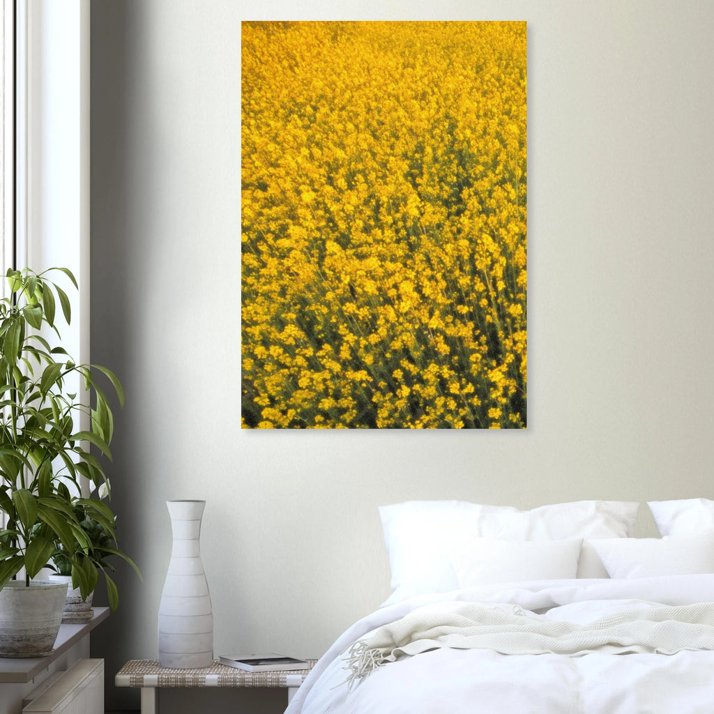 Yellow floral artwork poster on a wall above a bed with white bedding.