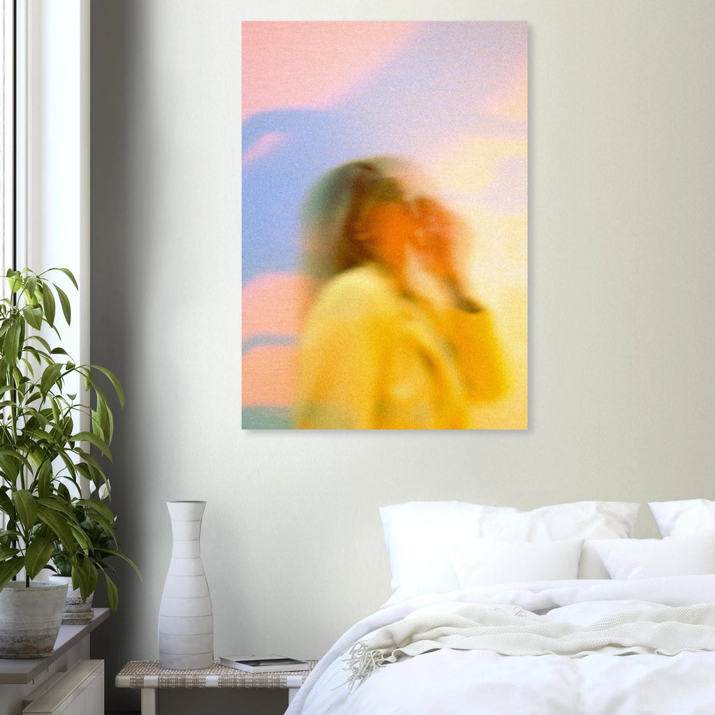 Abstract artwork poster of a woman in a yellow dress on a white wall above a bed.