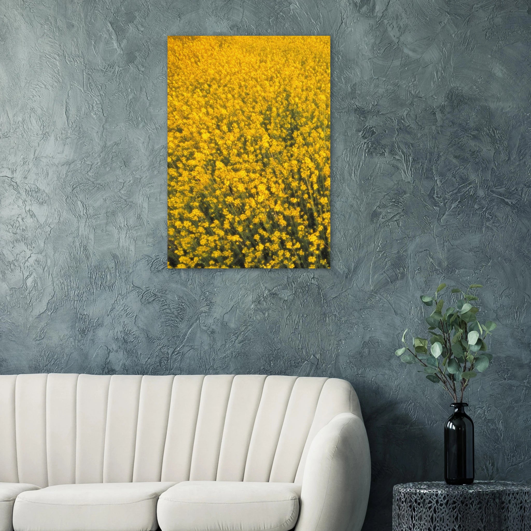 Yellow floral artwork poster on a gray wall above a white sofa.